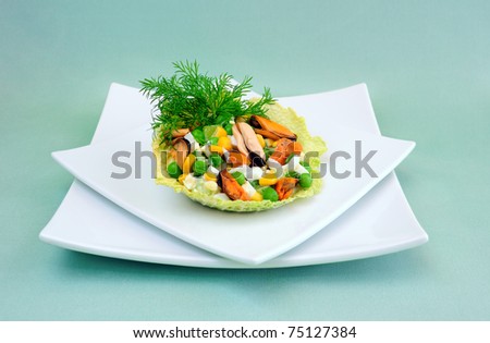 Salad of mussels with corn and peas in the leaves of savoy cabbage