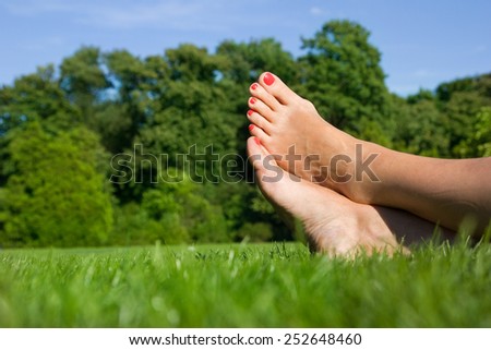 feet of woman relaxing at the park