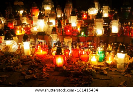 Candles on the grave on the evening of All Saints Day in Poland