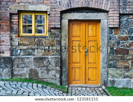 Vintage Wooden Door and Window in stone wall
