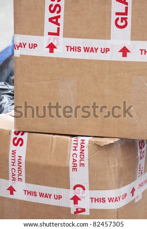 Stack cardboard boxes with 'handle with care'