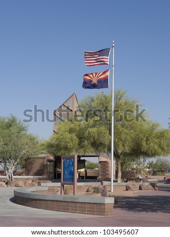 Arizona and US flags waving in strong wing on car rest area
