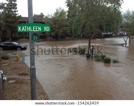 PHOENIX, US - SEPTEMBER 9, 2013: Car stuck in flooded road after heavy seasonal monsoon rain in Phoenix, Arizona