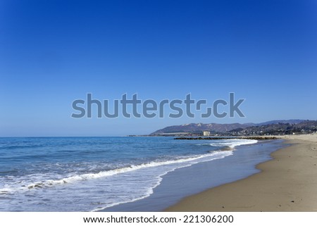 Central beach and distant hotel strip in Ventura, California southern coast line