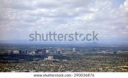 Arizona capital city of Phoenix surrounded by neighboring mountains on a rare cloudy day