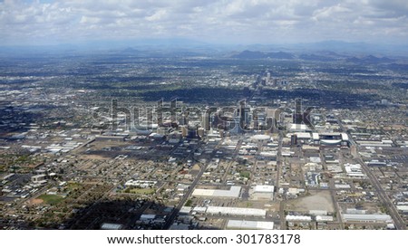 Arizona capital city of Phoenix surrounded by neighboring mountains on a rare cloudy day