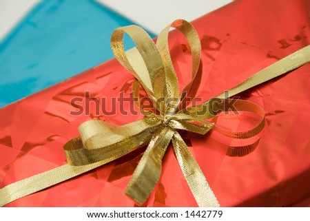 Gold Ribbon Bow on Shiny Red Gift Box