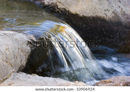 Beautiful nature waterfall on a small lake