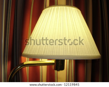 Comfortable Night Lamp against colored curtains; close up