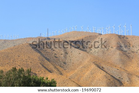 Blue Sky Smoke Free behind Electric Wind Mill Turbines
