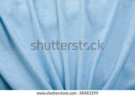 Folds of blue velvet drapery; close up