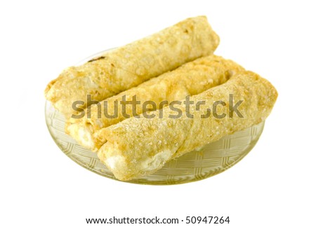 Three frozen egg rolls on plate, isolated on white background