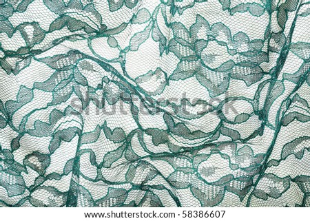 stock photo Green wrinkled lace on white spandex background macro view