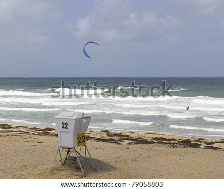 Adventurous kiteboarding in stormy ocean waves