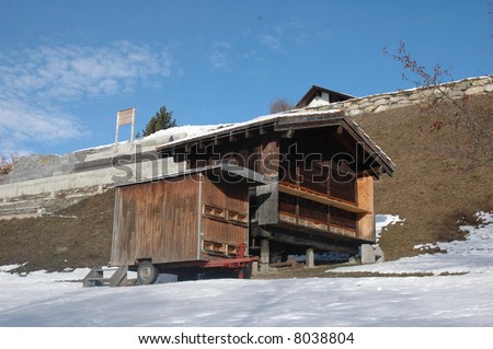 wooden bee house in the swiss alps around christmas time