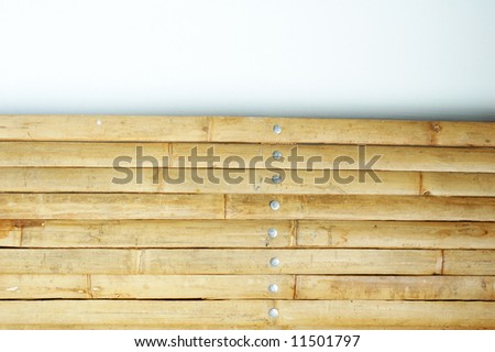 abstract background image featuring a bamboo partition against a white wall and space for text