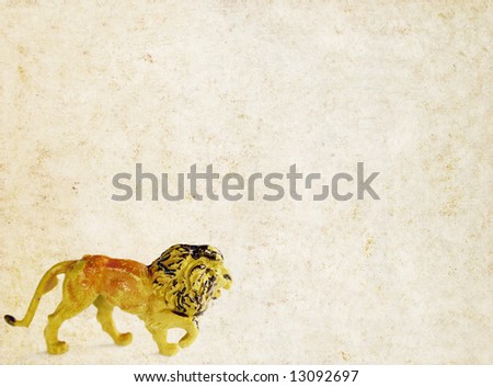 lovely brown background image with earthy texture, close-up of a toy lion and plenty of space for text