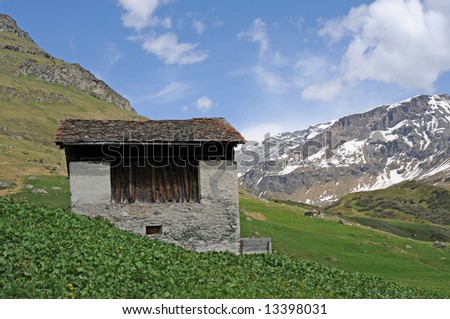 little house and panorama in the swiss alps