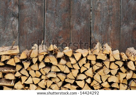 lovely background image featuring firewood against an olden wooden wall
