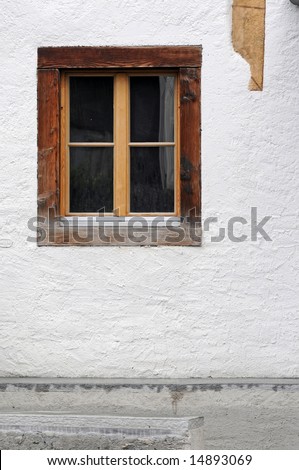 simple background image featuring a wooden window and an old whitewashed wall