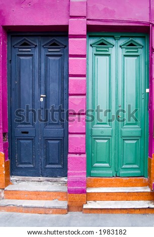 Two colored apartments doors with green, blue, pink and orange color