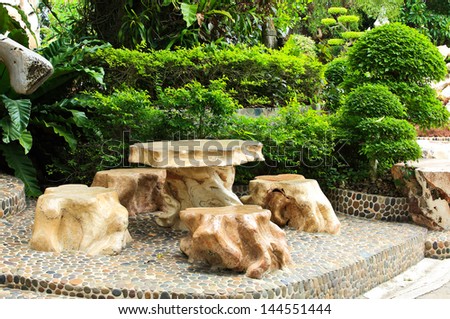 Stone chair and table in the garden.