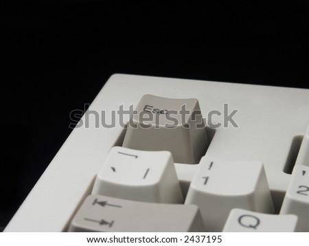 Escape key of computer keyboard and its edge against black background