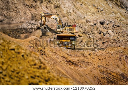 An open pit diamond mine in Botswana with heavy machinery on site.