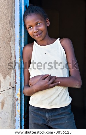 Social issues, poverty, African girl, underage farm worker, village near Kalahari desert