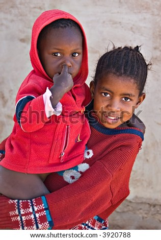 Deprived African children, sister and brother, village near Kalahari desert, people diversity series
