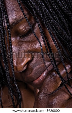 low-key African woman portrait, special light was used to make obvious the wrinkles,