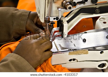 African American woman working at the bartack machine, industrial series
