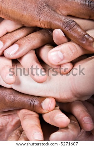 Background pile of hands, Caucasian, African American, Hispanic race.