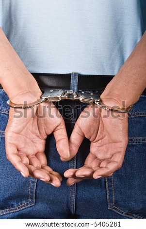 stock photo Man handcuffed hands at the back use it in security concepts