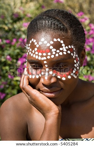 stock photo Young African girl tribal painted face in white and red