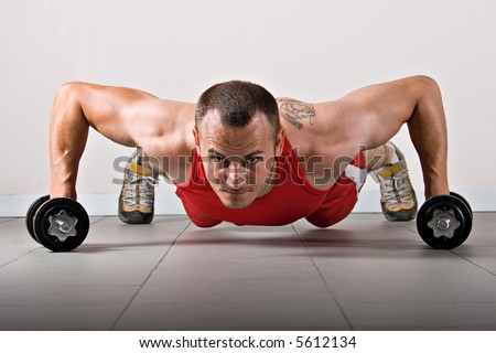 Push up with dumbbells, classic endurance exercise for biceps