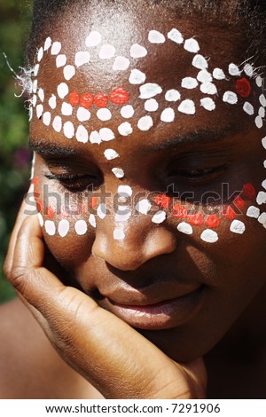 Young African girl, tribal painted face in white and red, this image is a straight RAW conversion, with powerfull highlights to emphase the black skin,