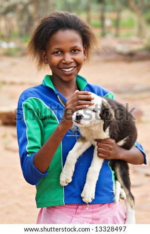 African girl with dog, picture taken in village near Kalahari Desert