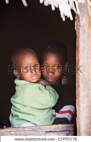 Small African children in the door of the village house