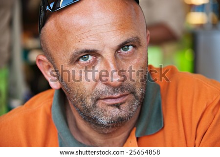 caucasian man in his forties with orange t-shirt