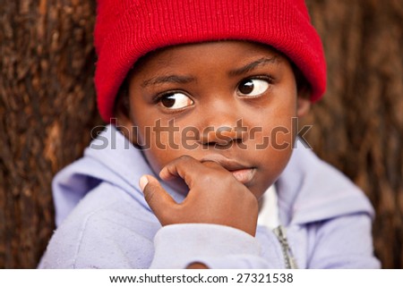 shallow DOF of african child , bark of tree background