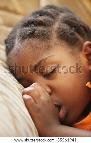 don\'t worry be happy, African child with braids sleeping on the couch