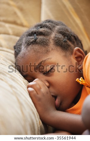don\'t worry be happy, African child with braids sleeping on the couch