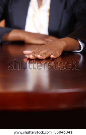 African American woman hand standing on the desk, corporate look clothes,
