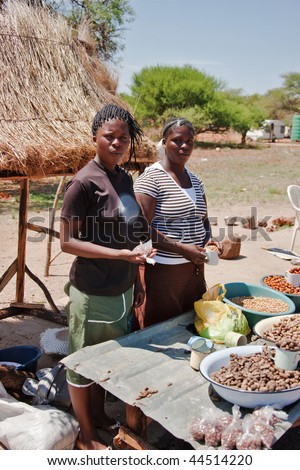two African street vendors selling local products