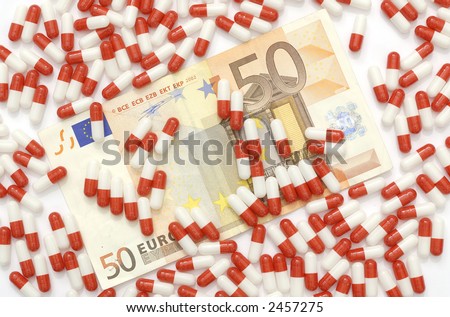 A 50 euros bill covered by red and white pills