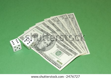 Dollar bills with a couple of dices on a casino table background