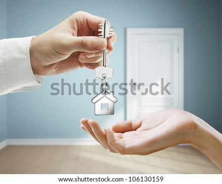 Passing Keys Against Backdrop Of Blue Room