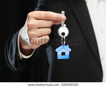 blue key chain with key in hand  businessman