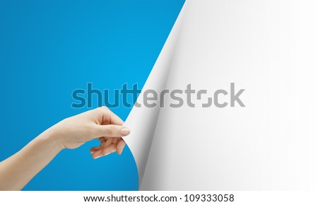 women hand turns blue page on white background